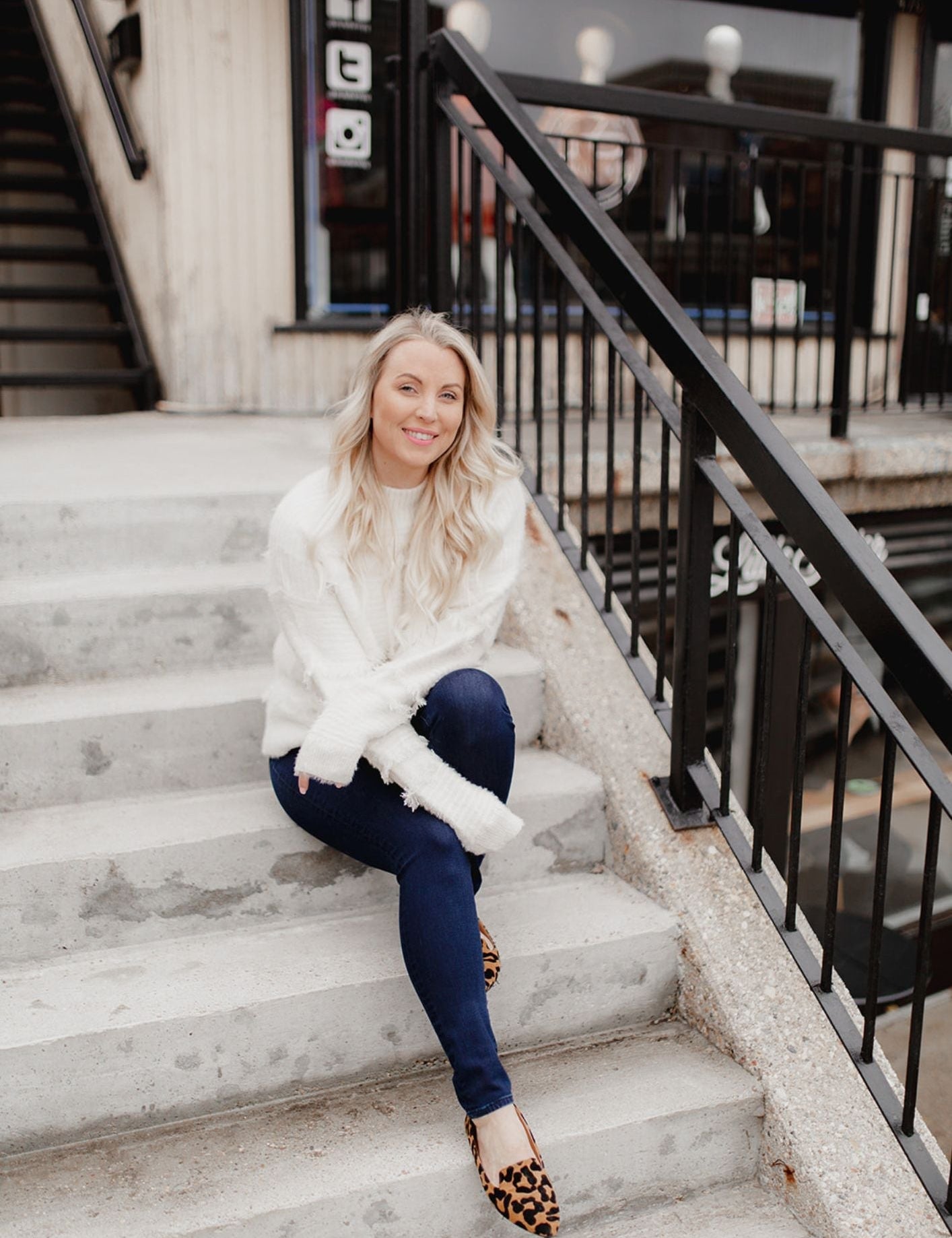 A woman sitting on stairs in casual fashion, explaining why I started a style bar, looking stylish and confident.