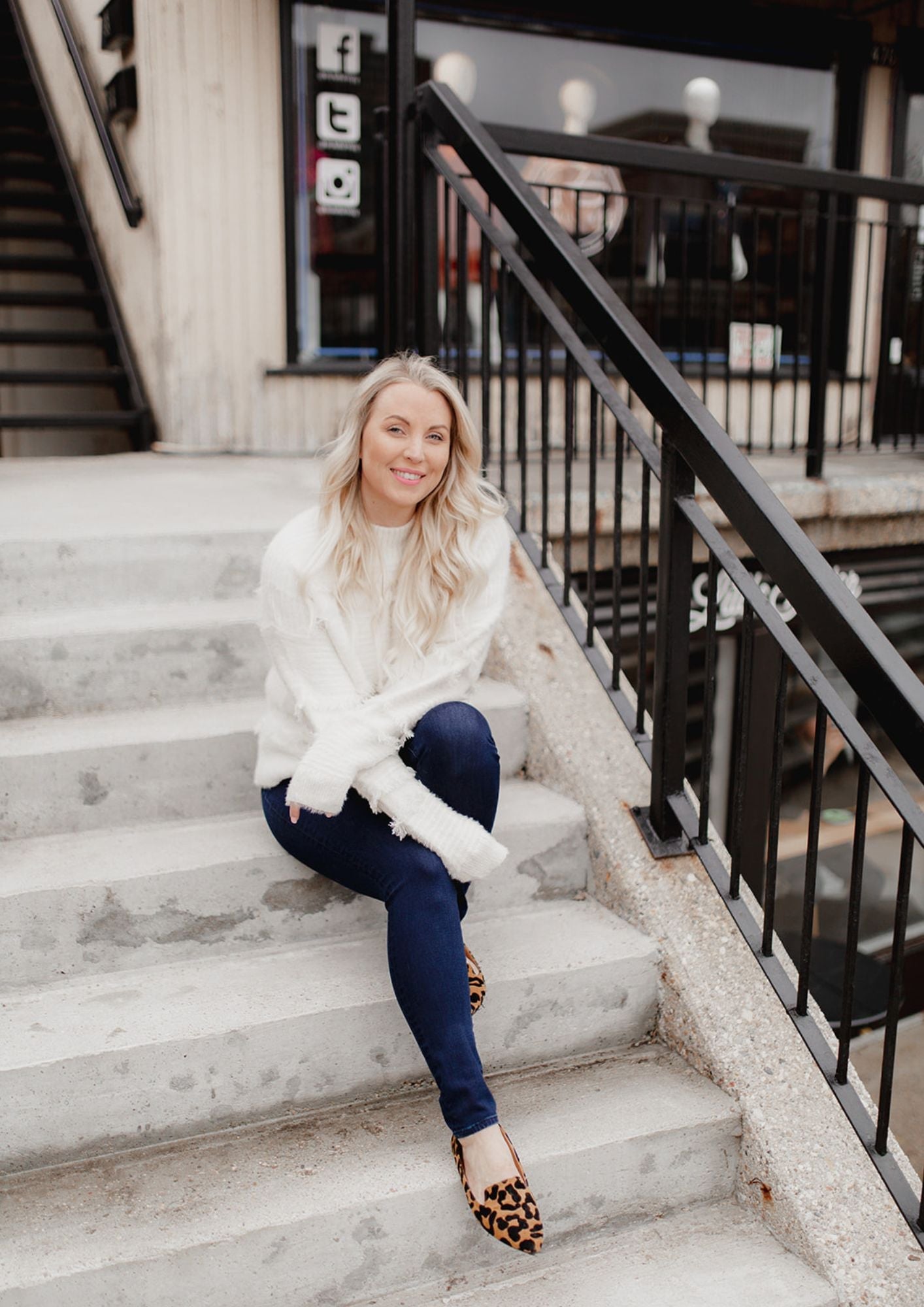 A woman sitting on stairs in casual fashion, explaining why I started a style bar, looking stylish and confident.