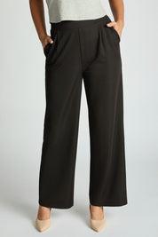 Harbor Waffle Trouser in black with a flattering bootcut silhouette and pockets, styled with a gray top and beige shoes.