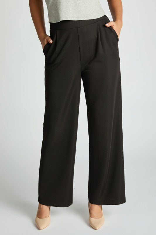 Harbor Waffle Trouser in black with a flattering bootcut silhouette and pockets, styled with a gray top and beige shoes.