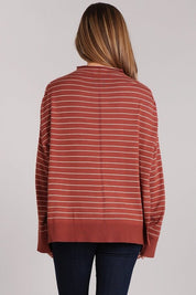 Back view of the Aubrey Knit Pullover in a rust striped design, showcasing its oversized fit and hi-low hem.