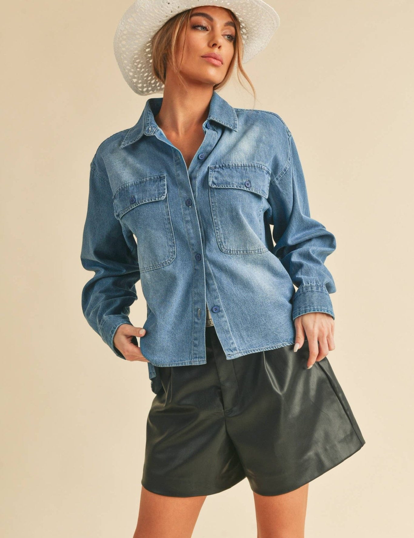 Genny Denim TopRevamp your style with this Genny faded denim shirt. Featuring button closure, spread collar, and long sleeves with button cuffs. The high-low hem adds a touch of edge, while the button-close chest pockets offer functionality and flair. Ele