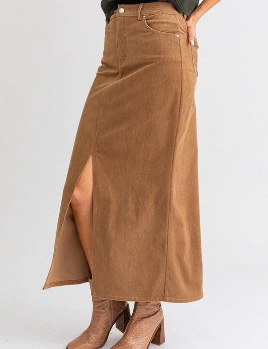 Ginni Midi Skirt - FINAL SALEFeaturing a high rise waist, midi length skirt with front slit. Soft corduroy fabric. SIZE & FIT Fit: This garment fits true to size.Fabric: Non Stretch FabricLength: Size S measures ** MODEL INFO 5'8" & wearing size Small Dis
