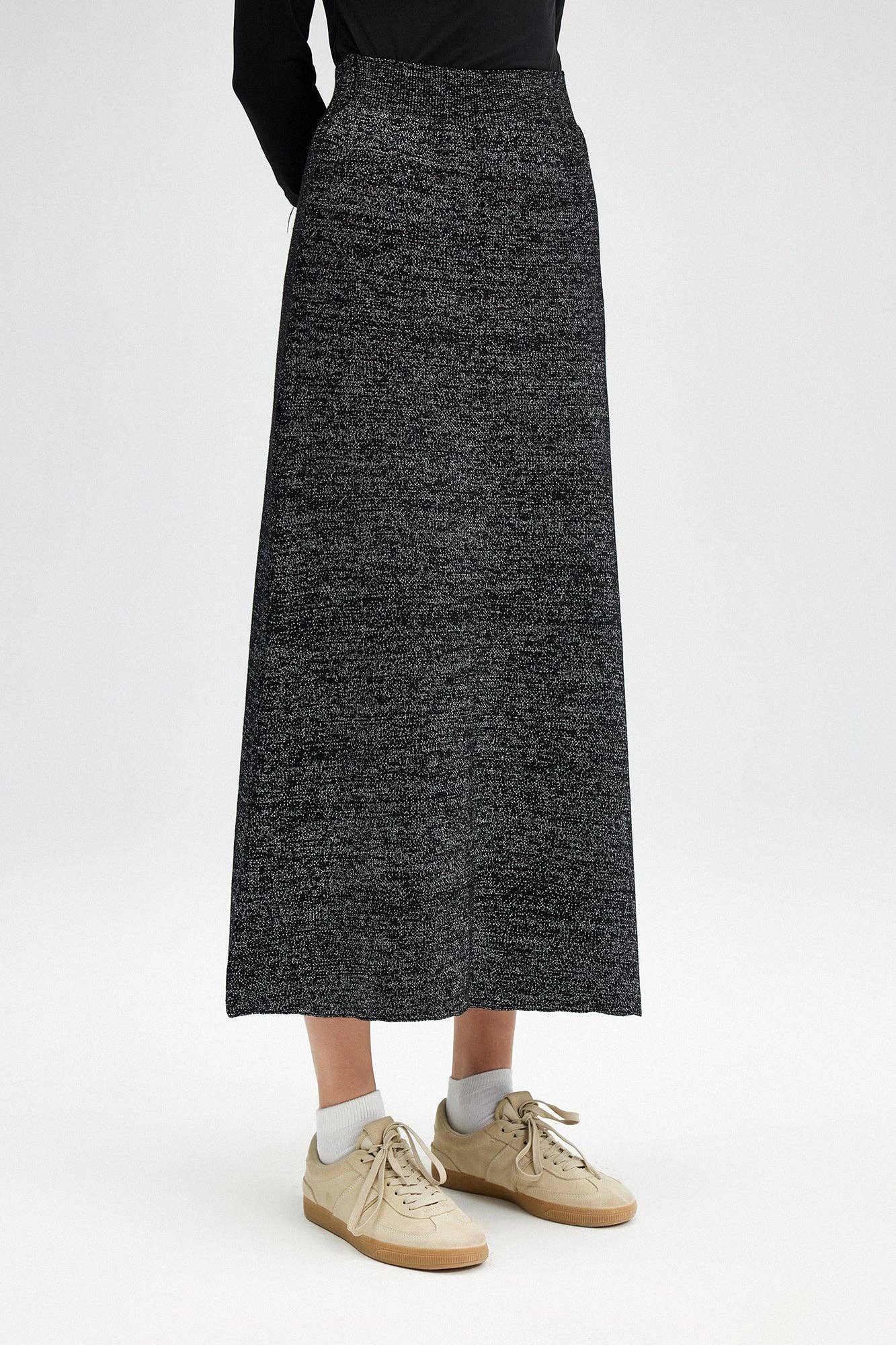 Glitter Maxi Skirt - FINAL SALEAdd a touch of sparkle to your winter wardrobe! This maxi skirt is made of a soft knit fabric, and features an elastic waist SIZE & FIT Fit: This garment fits true to size.Fabric: Stretch FabricLength: Size S measures 37" MO