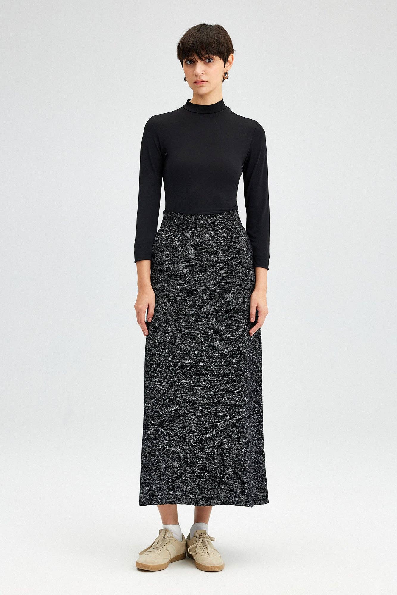 Glitter Maxi Skirt - FINAL SALEAdd a touch of sparkle to your winter wardrobe! This maxi skirt is made of a soft knit fabric, and features an elastic waist SIZE & FIT Fit: This garment fits true to size.Fabric: Stretch FabricLength: Size S measures 37" MO