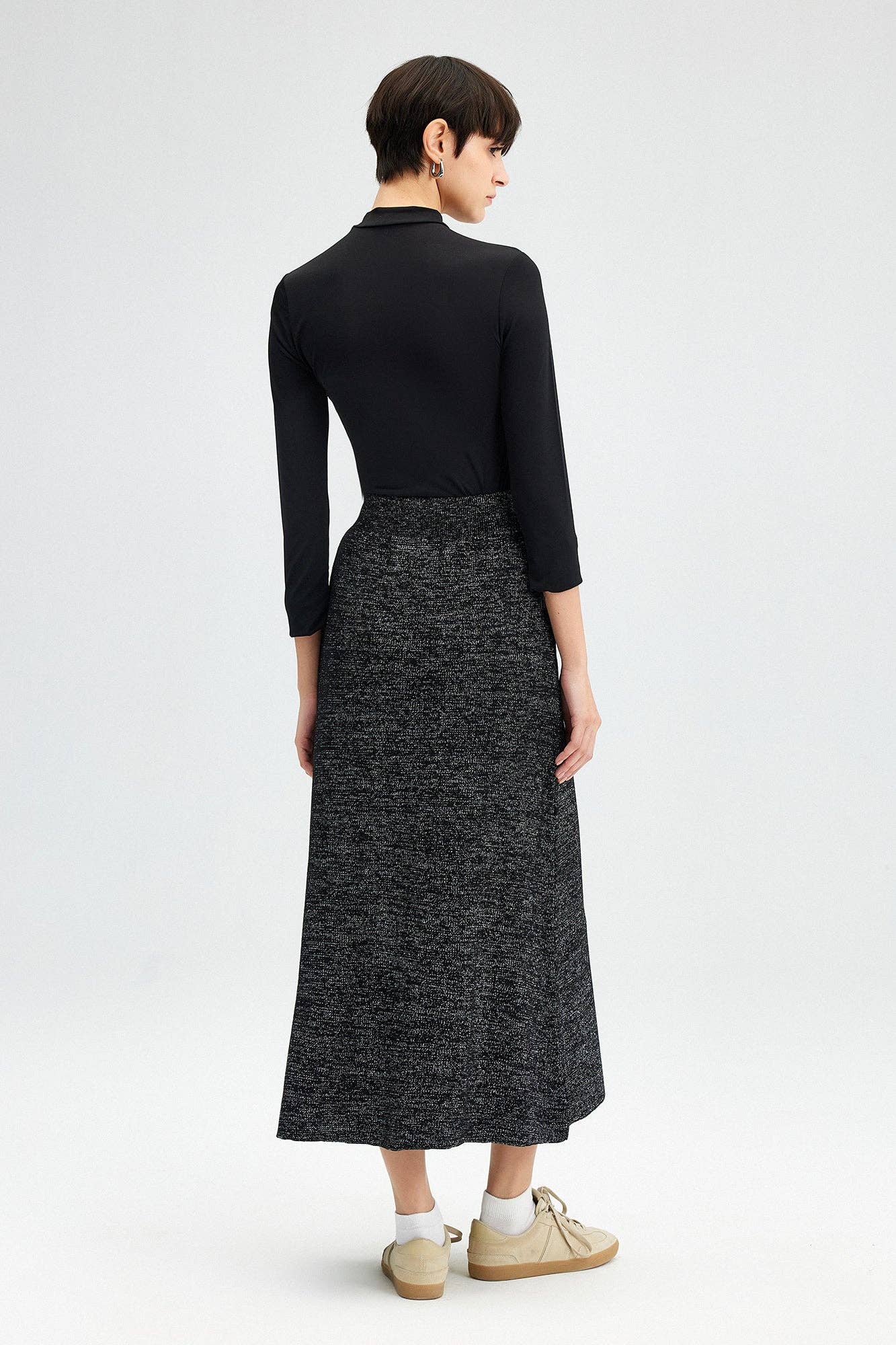 Glitter Maxi Skirt - FINAL SALEAdd a touch of sparkle to your winter wardrobe! This maxi skirt is made of a soft knit fabric, and features an elastic waist SIZE & FIT Fit: This garment fits true to size.Fabric: Stretch FabricLength: Size S measures 37" MO